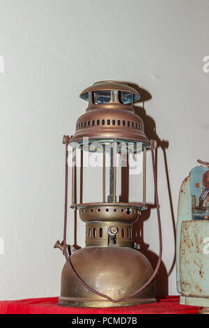 Antique hurricane lantern, shot with flash light. Vintage storm lantern/ old hurricane lantern for people who like to collect antique objects. Stock Photo