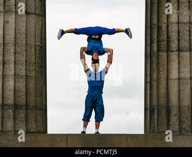 Edinburgh Fringe Festival, Edinburgh, UK. 3rd August 2018. Calton Hill, Edinburgh, Scotland United Kingdom: Photocall for Barely Methodical Troupe (BMT), an experimental acrobatic circus. Their 2018 fringe show is called SHIFT. Male performers on the National monument of Scotland performing acrobatics Stock Photo