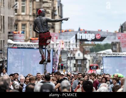 Edinburgh, UK. 3rd August 2018. Street performers take to the Royal Mile as the Edinburgh Fringe Festival kicks off.  Pictured: Tattooed street-performer entertaining the crowds on the Royal Mile Credit: Rich Dyson/Alamy Live News Stock Photo