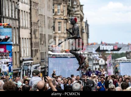 Edinburgh, UK. 3rd August 2018. Street performers take to the Royal Mile as the Edinburgh Fringe Festival kicks off.  Pictured: Tattooed street-performer entertaining the crowds on the Royal Mile Credit: Rich Dyson/Alamy Live News Stock Photo