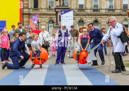 Glasgow, UK. 3rd July 2018, The Great Spacehopper Challenge took place in George Square, Glasgow as part of the Festival 2018 and European Games entertainments with children showing off their skills of balance, racing and really having fun. Here the race is between (L-R) James Edgar, age 3 and Stephanie Blair, age 8 both from Glasgow Credit: Findlay/Alamy Live News Stock Photo