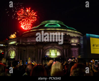 Edinburgh, UK. 3rd Aug 2018. Aberdeen Standard Investments sponsors the Edinburgh International Festival 2018 opening event Five Telegrams with a crowd in Festival Square. Celebrating Scotland’s Year of Young People and reflecting on the centenary of the end of the Great War with commissioned music by Anna Meredith and digital projection onto the Usher Hall by 59 Productions, the free outdoor event is Inspired by telegrams sent by young soldiers in 1918. Fireworks from the Edinburgh Tattoo before the event Stock Photo