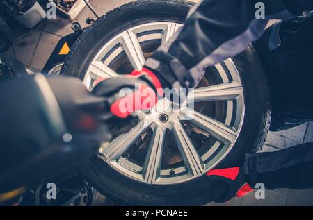 Car Tire Vulcanizing Service. Removing Tire From the Magnesium Alloy Wheel. Top View. Car Service Theme. Stock Photo