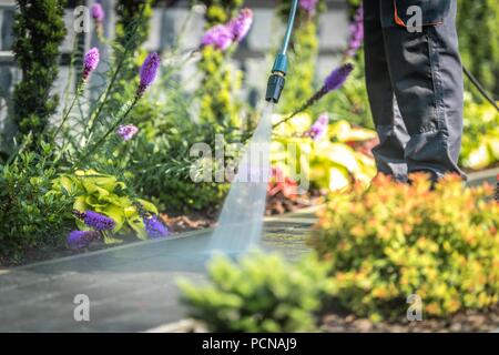 Power Washing Garden Cobble Stone Paths. Outdoor Cleaning Using Pressure Washer. Closeup Photo. Stock Photo