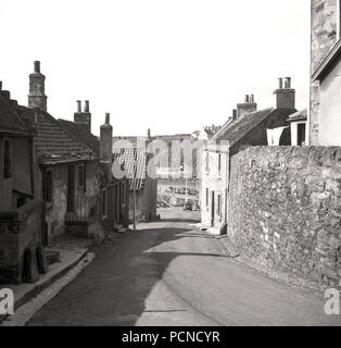 1950s, historical, daytime, summer and a view of a truck coming down a ...