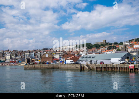 Looking across from the harbour wall to the lifeboat station in Scarborough. Stock Photo