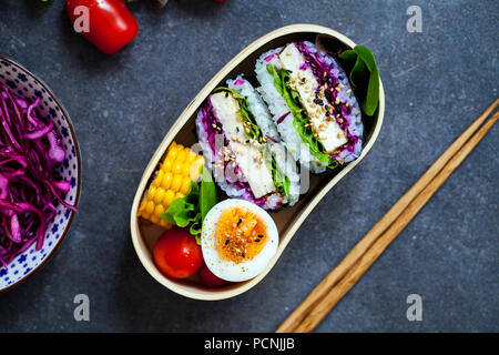 Japanese bento box with tofu onigirazu Stock Photo