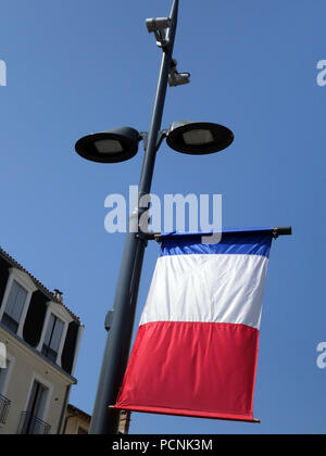 French Flag hanging on a streetlamp in Beziers France Stock Photo