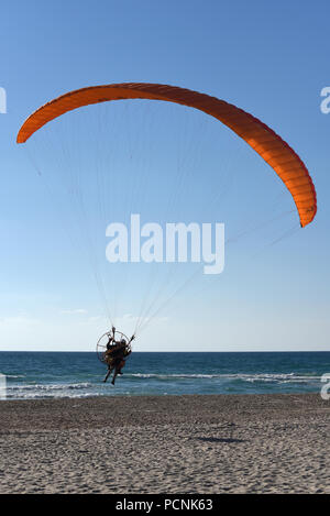 motor paragliding on the Mediterranean sea coast Stock Photo