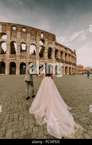 Lovely young wedding couple by the Colosseum in Rome, Italy Stock Photo