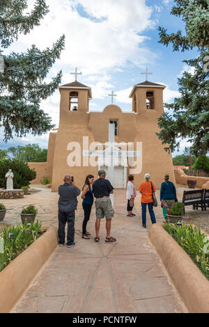 RANCHOS DE TAOS, NM, USA-12 JULY 18: The San Francisco de Asis Mission Church was finished in 1815. Image includes tourists at front of church. Stock Photo