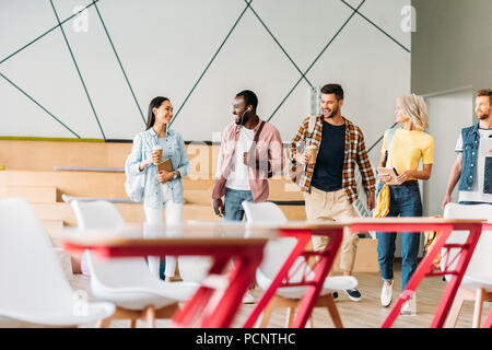 group of young students spending time together in lecture room of college