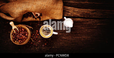 Espresso,milk jug and freshly roasted coffee beans on wooden table Stock Photo