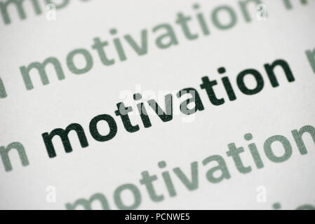 word motivation printed on white paper macro Stock Photo