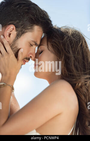 portrait of beautiful happy couple hugging and going to kiss Stock Photo