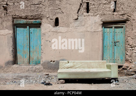 Oman, Al Hamra, two green doors and old sofa Stock Photo