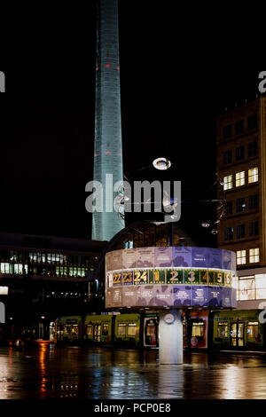 The world time clock at night time in the rain on the Alexanderplatz square in Berlin. Stock Photo