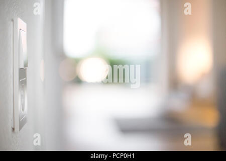 Closeup of a light switch with a power outlet, blurred background Stock Photo