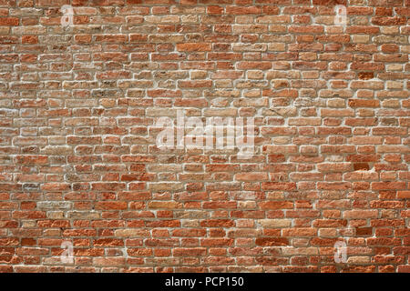 Old red brick wall texture background in sunlight with shadows Stock Photo