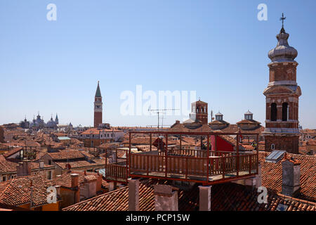 Venice roofs with typical altana balcony and San Marco bell tower in summer, Italy Stock Photo