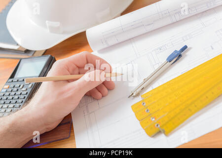 Architect at work. Construction plans, blueprint, measure, ruler and drawing tools Stock Photo