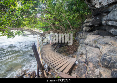 Cliffside wooden path over the water from Ao Nang beach to secluded centara resort beach Stock Photo
