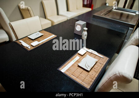 Catered table in asian restaurant. Chopsticks and soy sauce. Stock Photo
