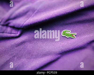 Rome, Italy, august 3rd 2018: close up view of a Lacoste purple polo shirt. Focus on the sewn crocodile Stock Photo