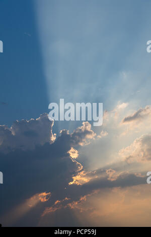Sun shining from behind thunder clouds on a summers evening. North Yorkshire, UK. Stock Photo