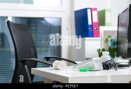 Doctor office in hospital, emergency room or health care center. Physician, nurse or practitioner table, desk and workstation with medical equipment. Stock Photo