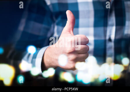 Man showing thumbs up in modern and abstract space. Happy business person giving satisfied and supportive hand gesture. Stock Photo