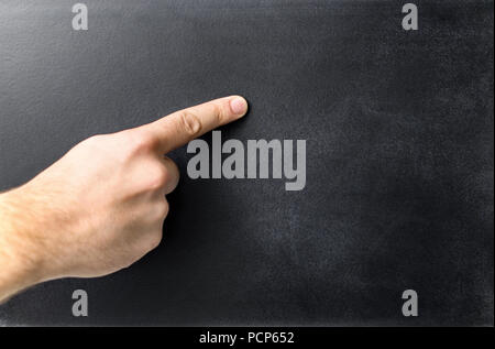 Teacher pointing empty blackboard. Hand and finger on a blank chalkboard. Negative copy space. Stock Photo