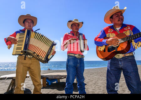 Monterrico, Santa Rosa, Guatemala - February 1, 2015: Mariachi musicians perform for beach goers at Monterrico beach in Santa Rosa department. Stock Photo