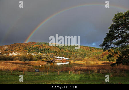 The first glimpse of sun sees 42073 passing Fell foot on  the Lakeside & Haverthwaite Railway. Stock Photo