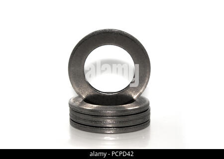 A few big industrial galvanized steel washers on white background Stock Photo