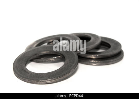 A few big industrial galvanized steel washers on white background Stock Photo