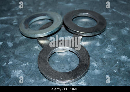 Three big galvanized industrial steel washers Stock Photo