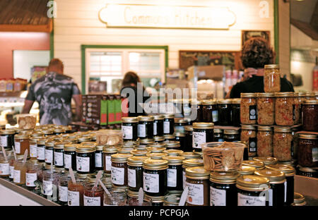 Rows of Amish homemade canned jams for sale alongside opened jars for sampling are displayed in an Amish country store in Ohio. Stock Photo