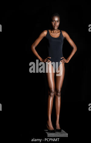 Pretty black woman standing in a black bodysuit. Stock Photo by  ©natalliajolliet 76034909