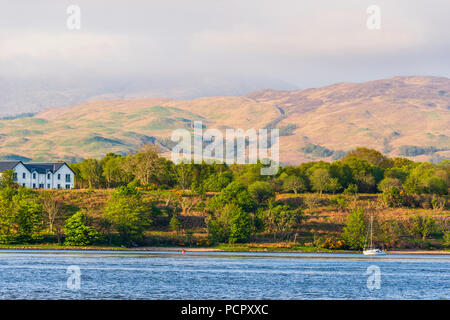 sunset over the Connel bridge and Lora waterfall Stock Photo
