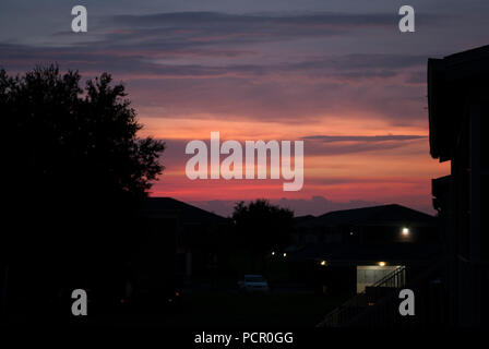 Bloody sunset and homes. Stock Photo