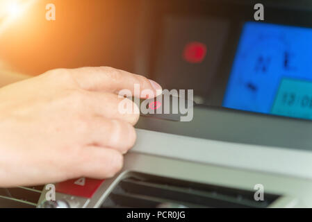 Switching on electric parking brake in a car Stock Photo