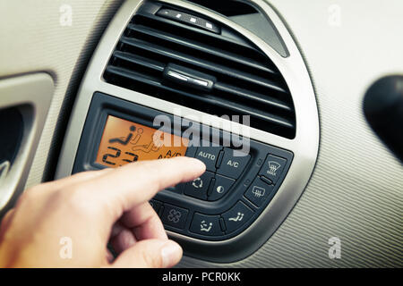 Driver using ac air-condition system and pushing button car screen interface Stock Photo