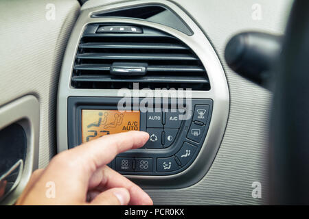 Driver using ac air-condition system and pushing button car screen interface Stock Photo