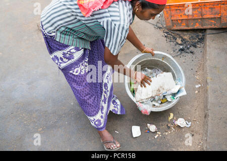 Indian woman take garbage in the street Stock Photo