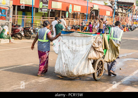 Indian woman take garbage in the street Stock Photo
