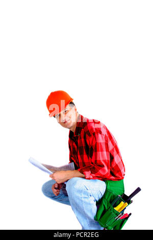 Contractor kneeling with a blueprint  and tool belt isolated on a white background Stock Photo