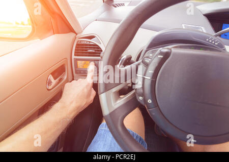 Driver using ac air-condition system and pushing button car screen interface Stock Photo