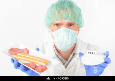 Researcher presenting preservatives substances that are added to products such as foods, pharmaceuticals, paints, biological samples, wood etc. to pre Stock Photo