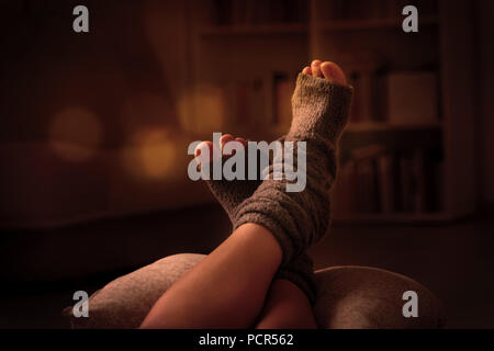 Woman's feet lying on pilow in the cozy room. Stock Photo
